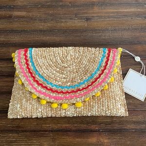 Colorful clutch with poms